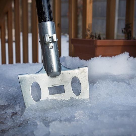 Close-up of the ice chopper in the snow.