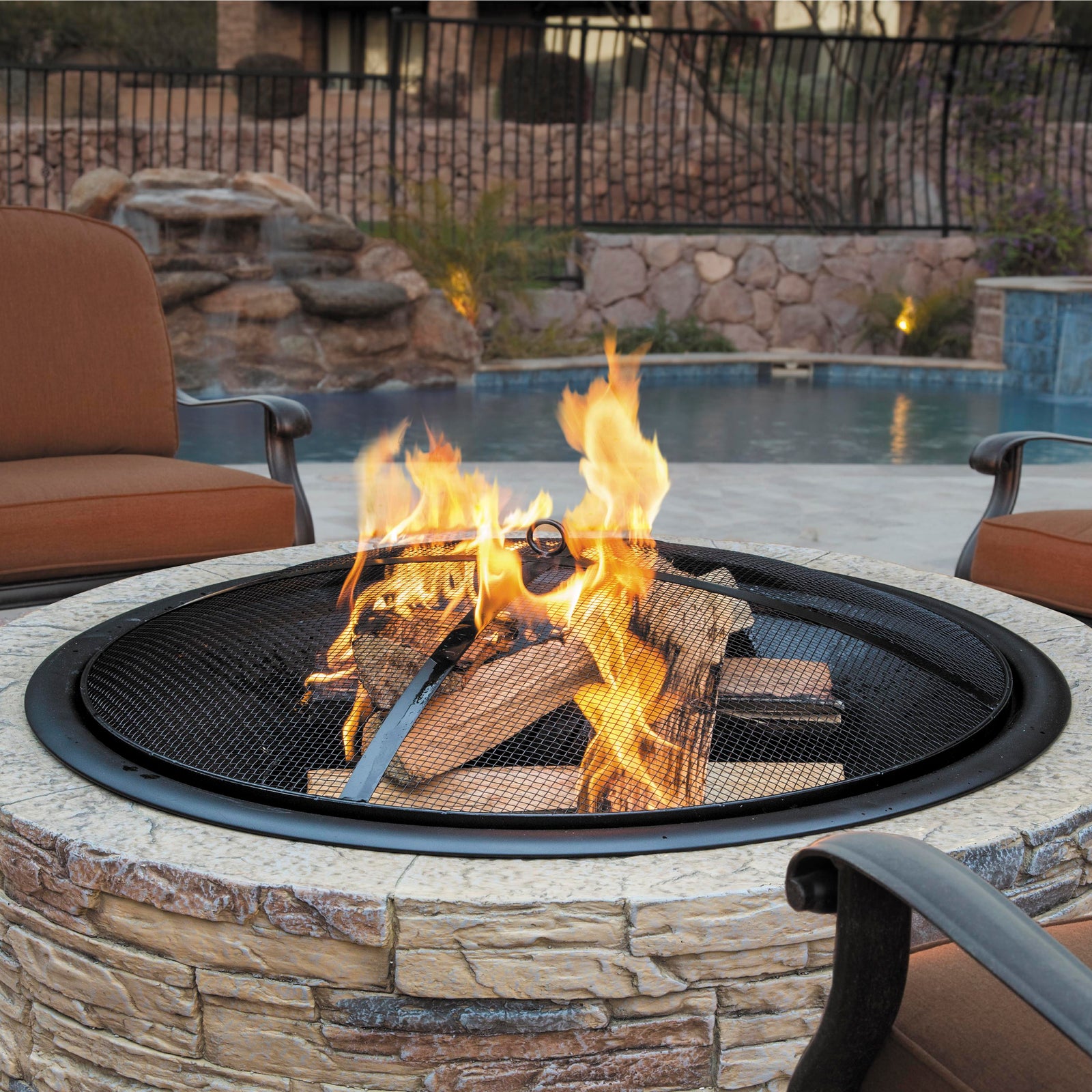 35-inch wood burning fire pit outside with logs buring.