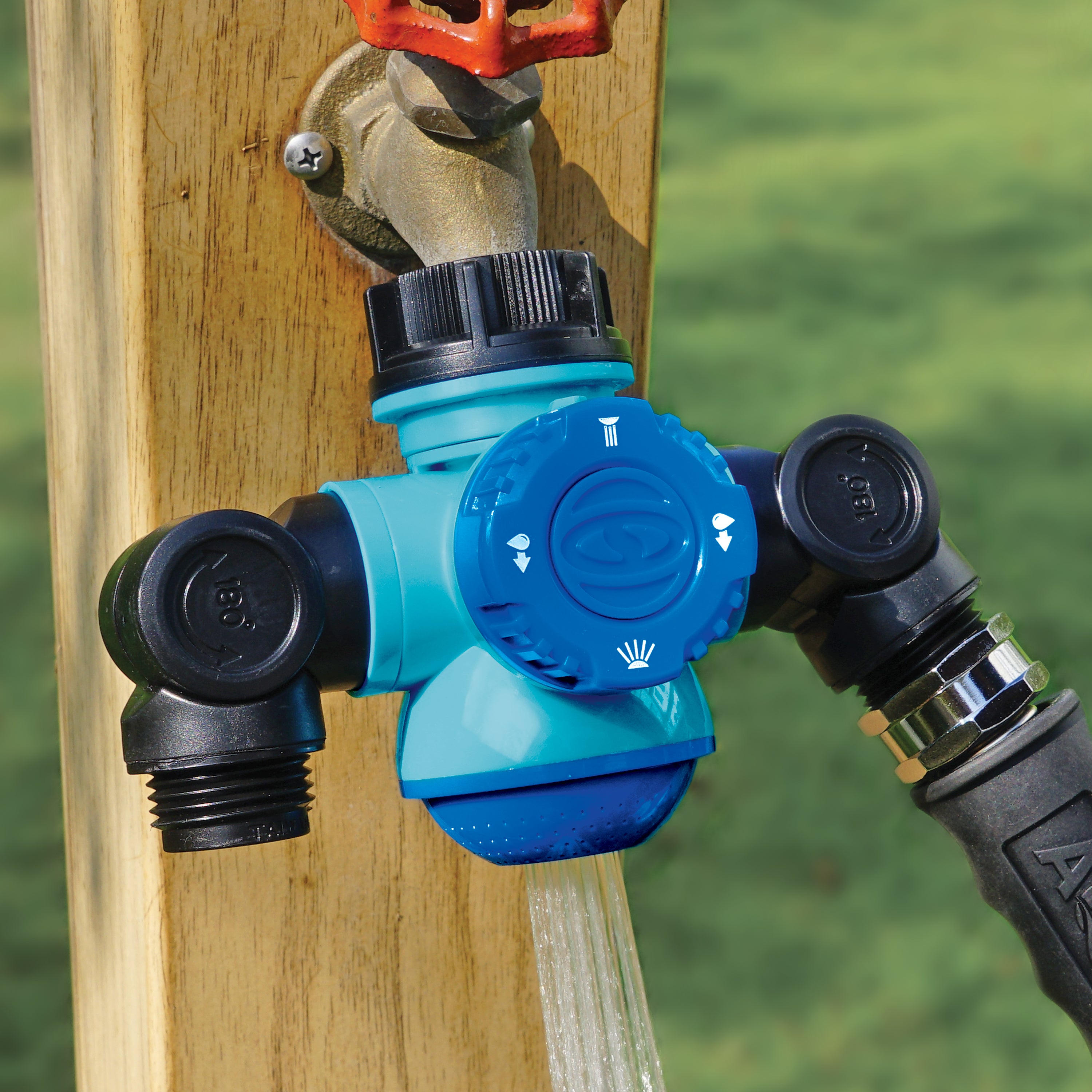 Soaker spray setting for the Aqua Joe Multi-Function Outdoor Faucet and Dual Garden Hose Tap Connecter connected to a hose.