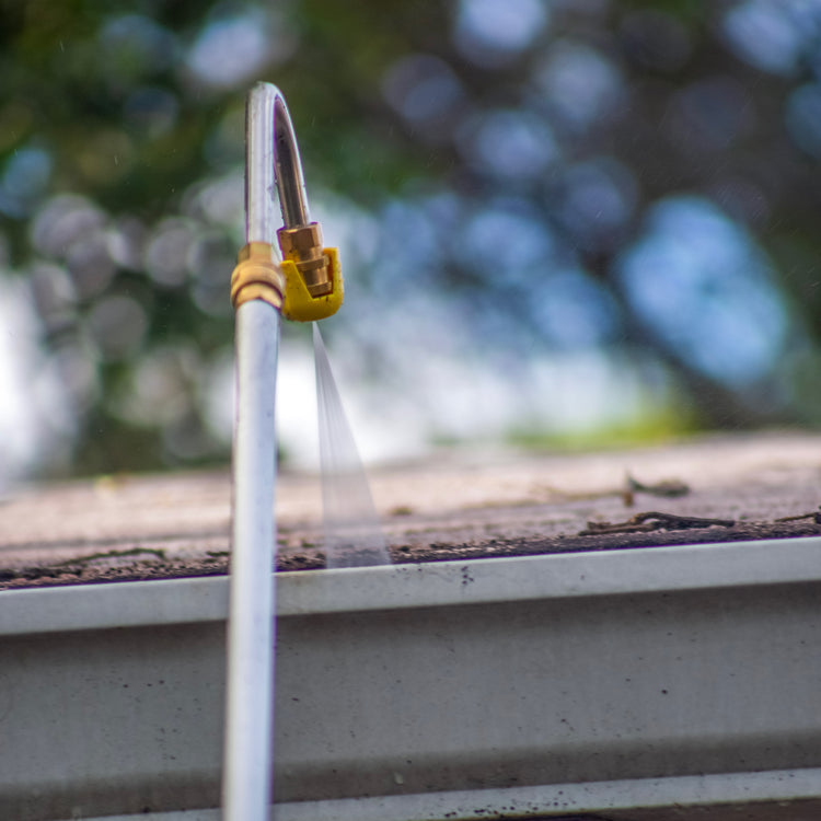 Close-up of the gutter attachment cleaning the gutter of a house.