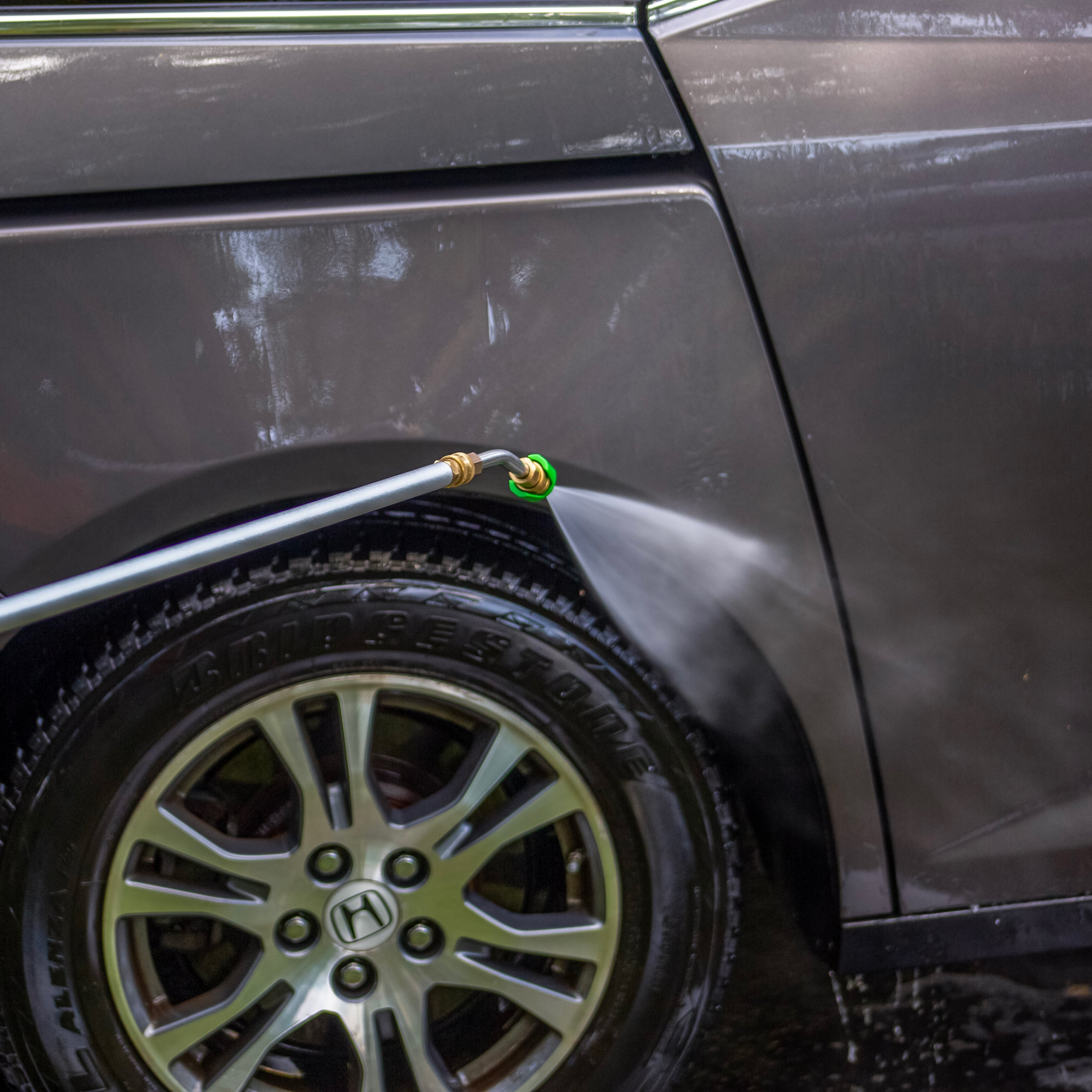 Sun Joe 9-Foot Universal Pressure Washer Sky Lance washing a car.