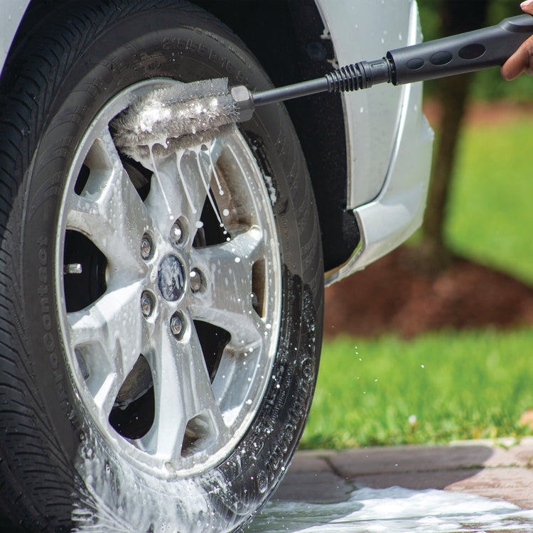 Rim and wheel brush scrubbing the rims of a car.