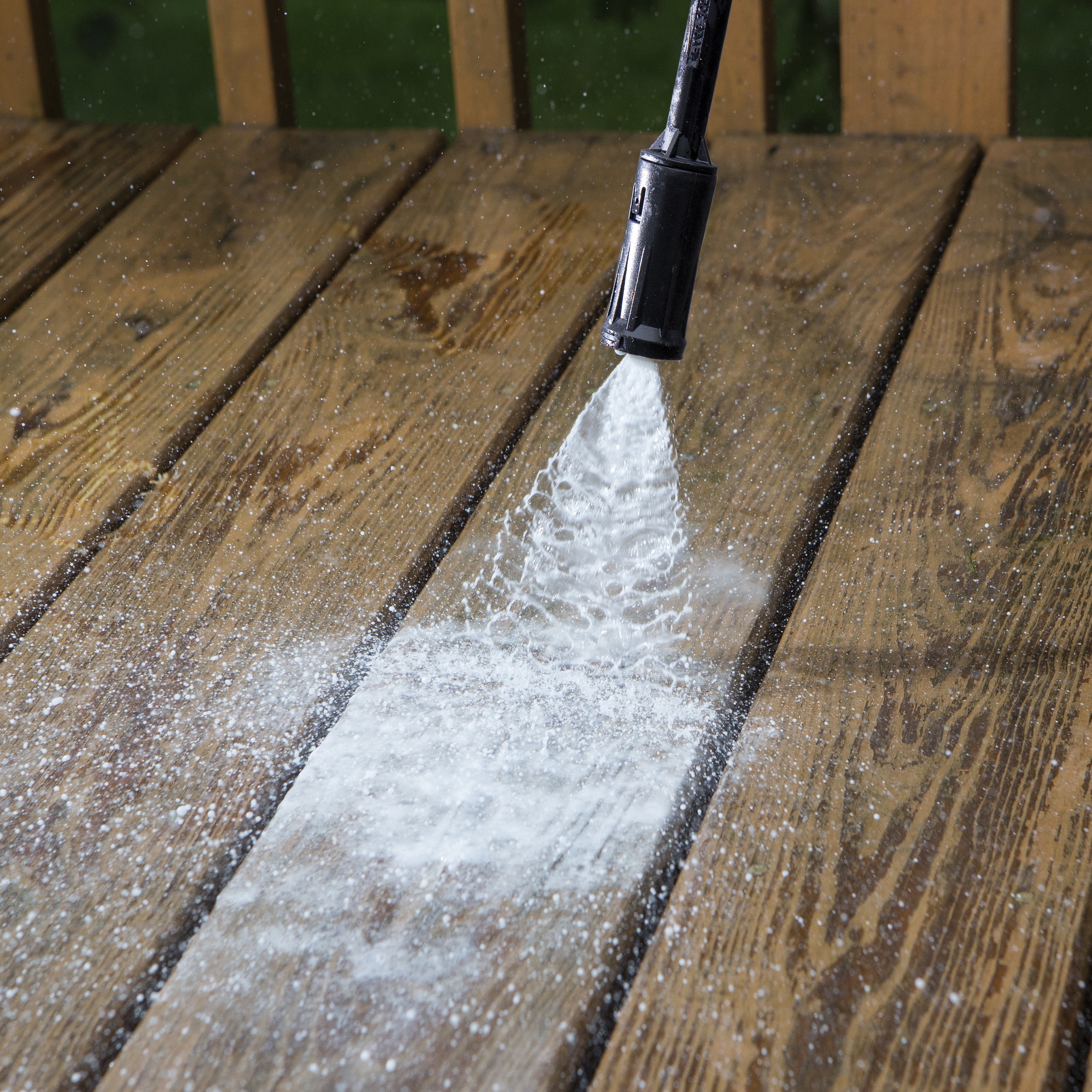 Sun Joe 11-amp Electric Pressure Washer with 1450 PSI being used to clean a deck.