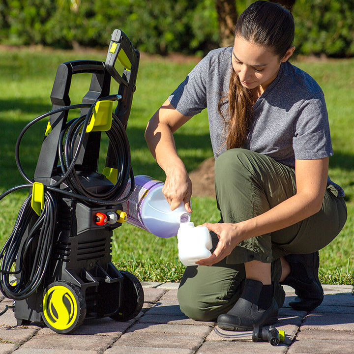 Woman refilling the detergent tank for the Sun Joe 13-amp 1950 PSI Electric Pressure Washer.