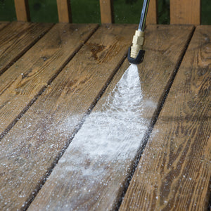 soap nozzle being used to apply soap to deck