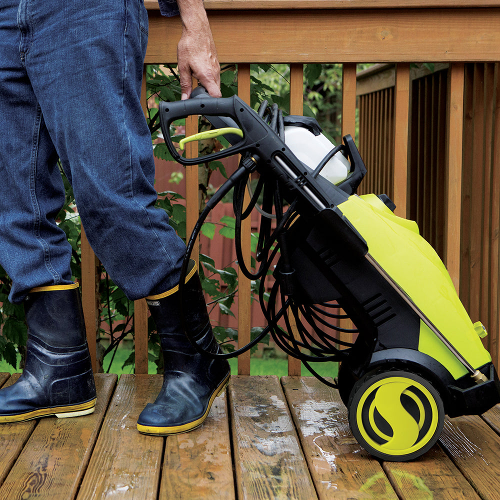 Sun Joe 14.5-amp 2030 PSI Electric Pressure Washer being wheel across a patio deck.