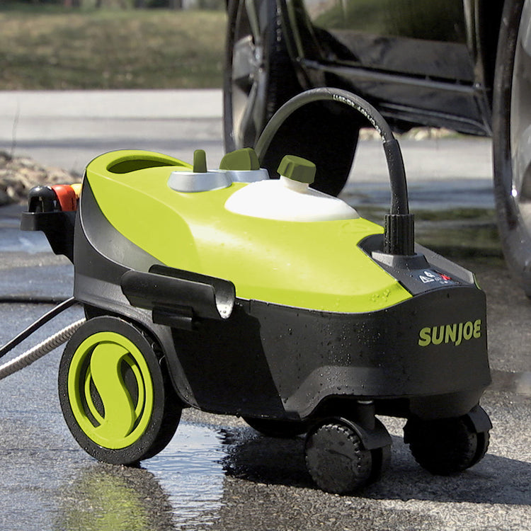 Sun Joe 14.5-amp 2030 PSI Portable Electric Pressure Washer in a driveway next to a car.