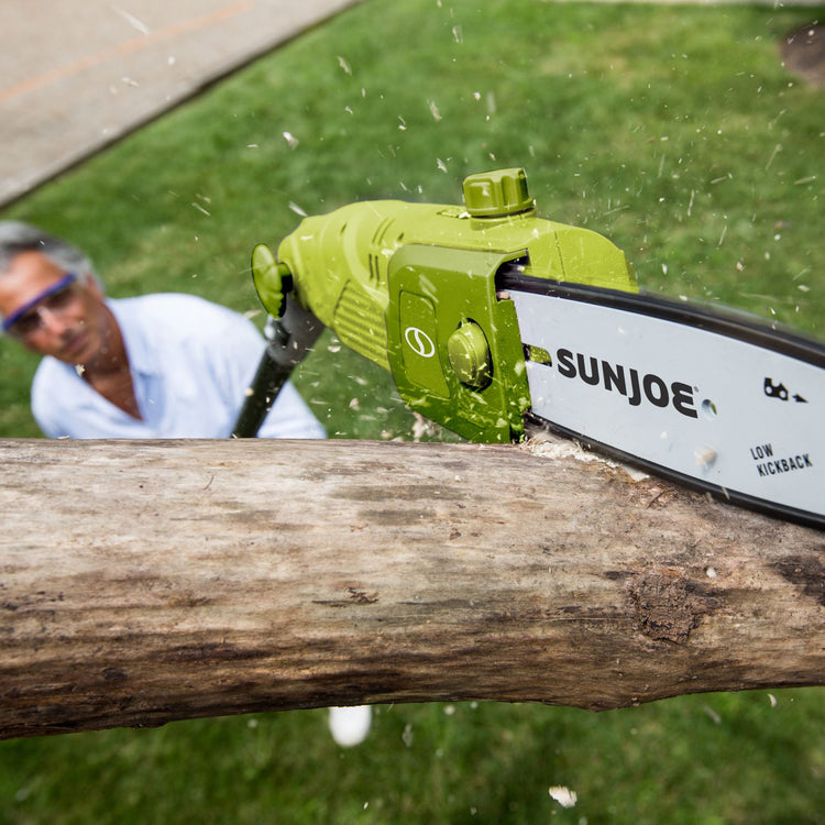 Sun Joe 6.5-amp 8-inch Electric Multi-Angle Pole Chain Saw cutting a tree limb.