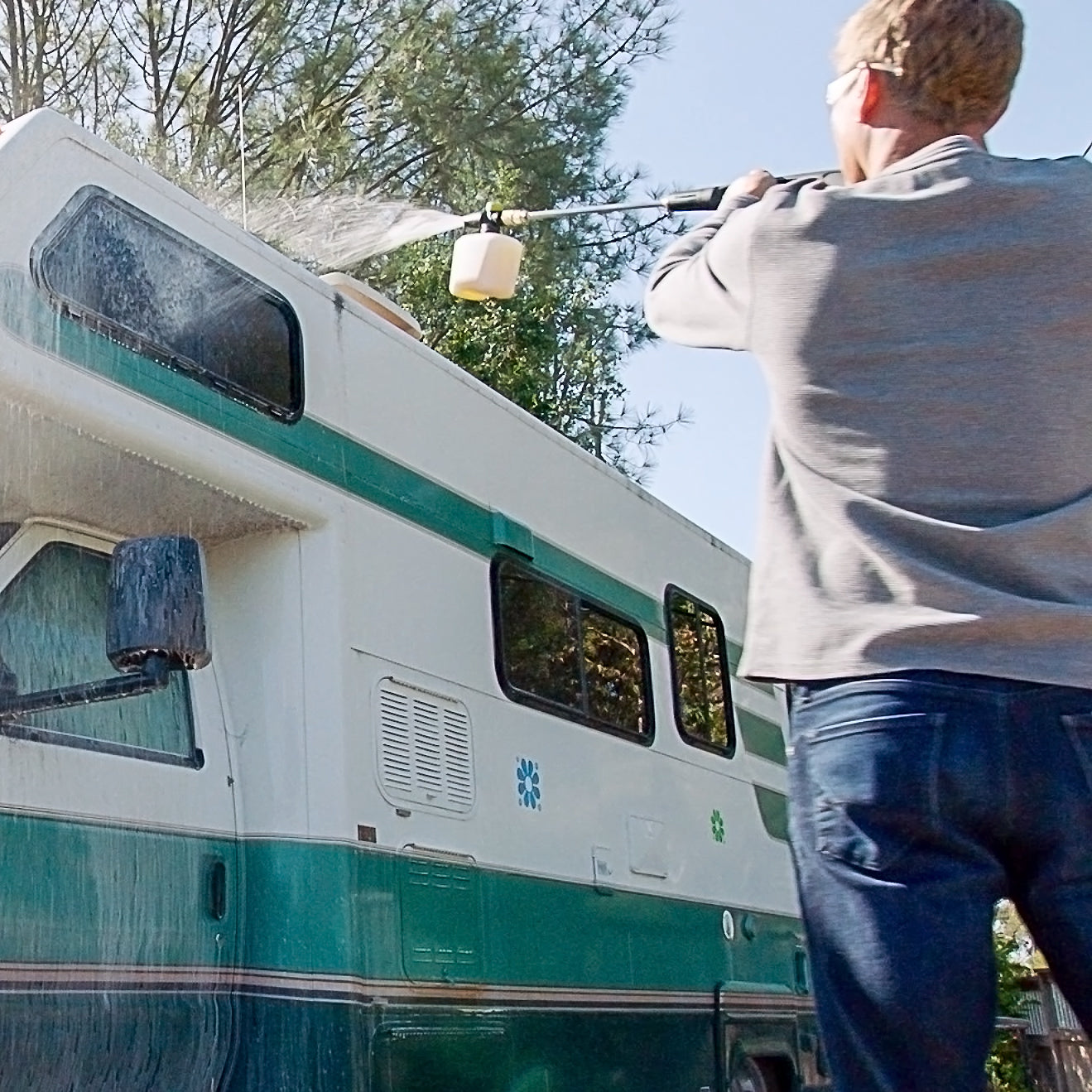 Sun Joe pressure washer detergent being used to wash an RV.