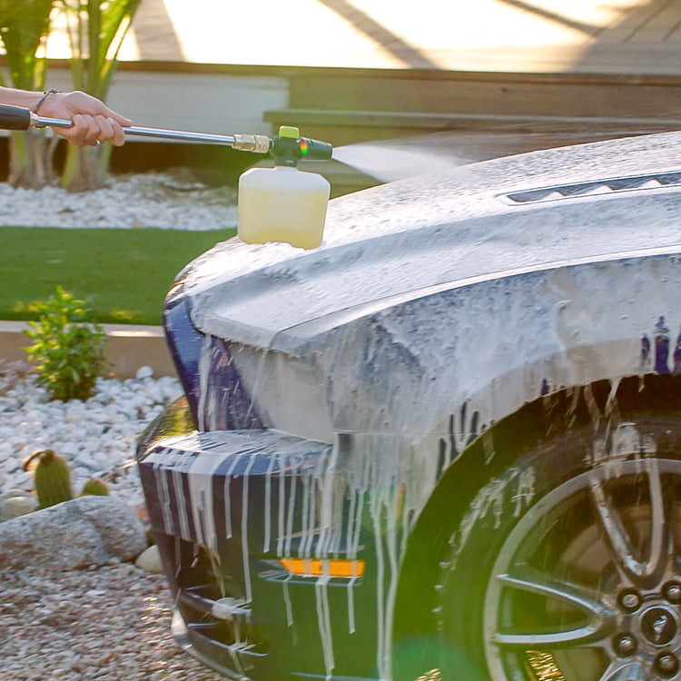 Sun Joe pressure washer detergent being used with a foam cannon to wash the hood of a car.