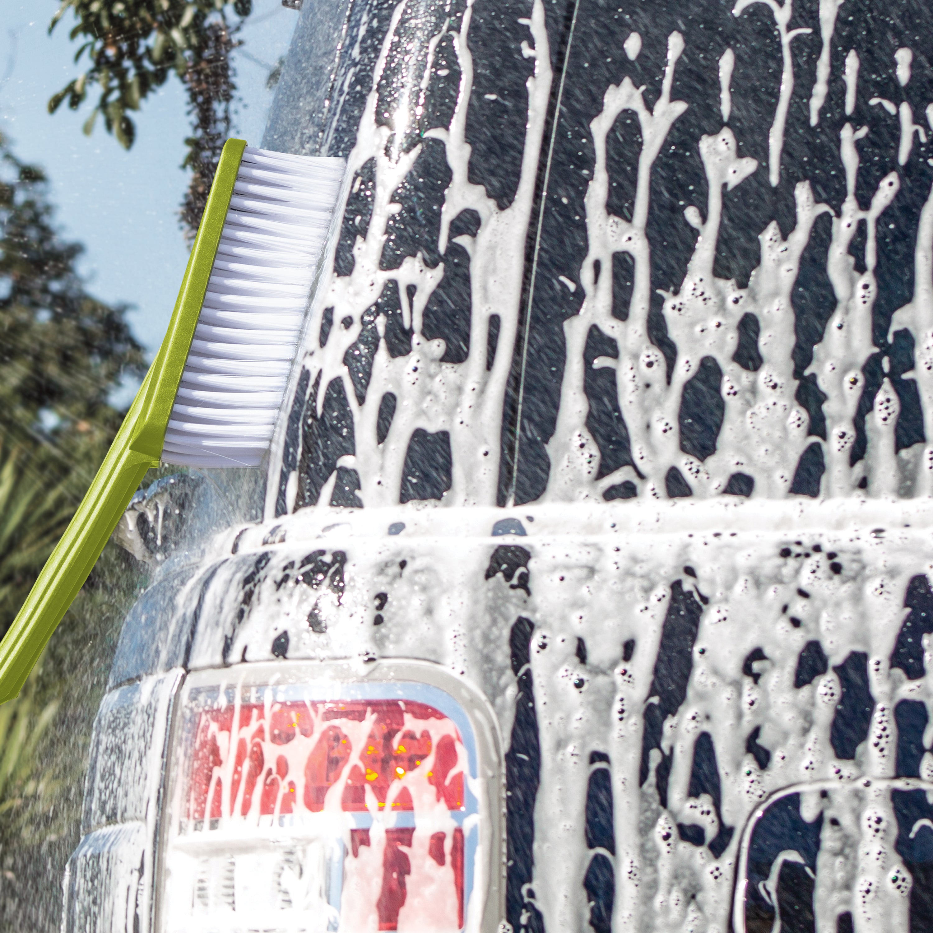 Sun Joe utility brush being used to scrub a car.